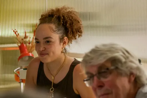 Woman and man listen during a community assembly