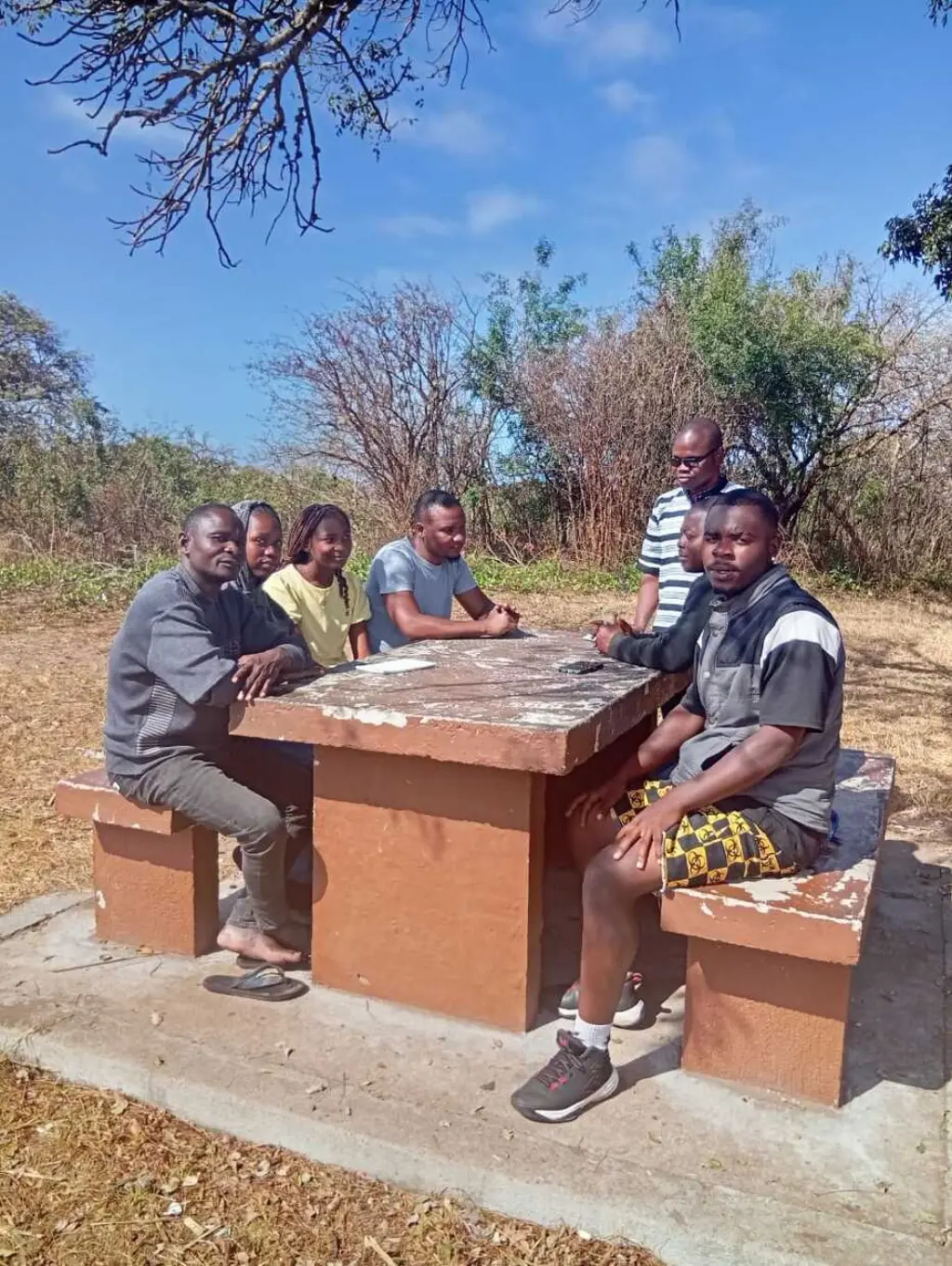 The Agricultors' childrensons sat around a table outdoors in the sunshine